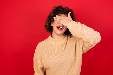 Wall Mural - Happy MODEL closing eyes with hand going to see surprise prepared by friend standing and smiling in anticipation for something wonderful.