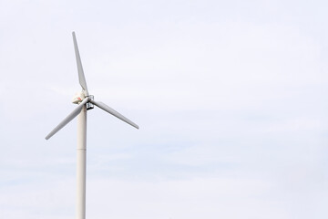 Windmill against a blue sky, generate energy from the wind