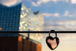 detail of a heart shaped lock with famous concert hall in Hamburg hafencity in the background at sunset