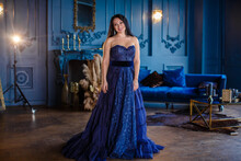 Beautiful Woman In A Blue Ball Gown And Blue Room