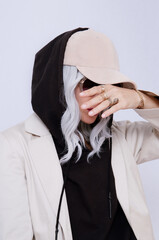  Blonde Girl in white studio. Trendy beige casual outfit with black hoodie details. Cap, Denim Suit Jacket and Pants. Street Style. Fall winter season.  Fashion lookbook concept