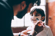 © Connect Images - Father painting daughter's face for Halloween