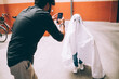 © Connect Images - Father photographing child dressed as ghost