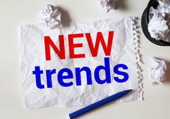 New Trends text written on notebook with glasses, magnifier end pen. Main trend of changing something.