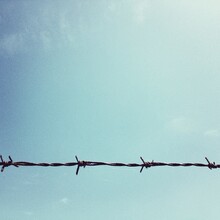 Close-up Of Barbed Wire Against Sky