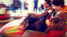 Blurred Motion Of People Having Fun In Bumper Car At Amusement Park