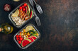 Meal prep containers with chicken, rice, avocado, tomato, corn, peas, watermelon radish, asparagus