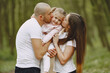 © hetmanstock2 - Family in a summer forest. Woman and man in a white t-shirts. Daughter with parents.