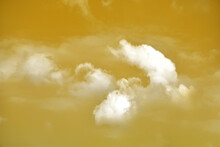 Golden Sky With White Clouds. Beautiful Sky Background And Wallpaper For Design And Texture Background.