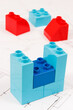 Plastic colorful toy blocks and construction diagrams of house. Building or buying home concept