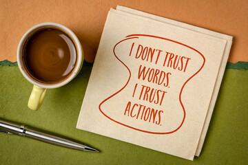 Wall Mural - I do not trust words. I trust actions. Inspirational handwriting on a napkin with a cup of coffee. Personal development concept.