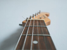 Close-up Of Guitar Against White Background