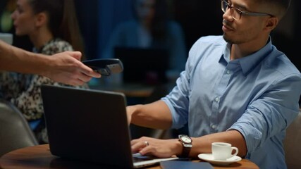 Indian businessman using laptop in cafe. Male programmer working on laptop