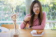 © Chaiwat - Asian women enjoy eating fried chicken in restaurant.