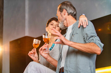 Wall Mural - aged couple with glasses of wine