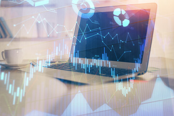 Stock market graph and table with computer background. Double exposure. Concept of financial analysis.