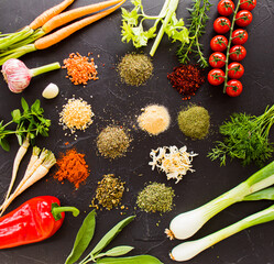 Wall Mural - Fresh vegetables around piles of dry seasoning