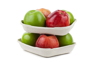 Wall Mural - Fresh red and green apples in pulp paper trays on top of each other. Studio photo isolated on white.