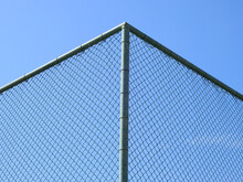 Wire Mesh Of Fence With Blue Sky Background