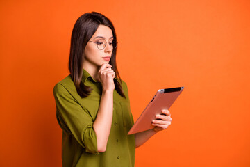 Wall Mural - photo portrait of thoughtful brunette student browsing internet with device tablet isolated on vibra