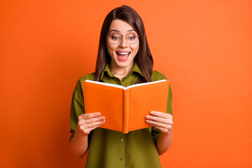 Sticker - Photo portrait of amazed happy female student wearing eyewear reading book smiling isolated on vivid orange color background