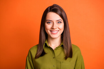 Wall Mural - Photo of lovely young girl look camera toothy beaming smile wear green shirt isolated orange color background