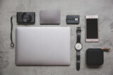 Fototapeta  - Work on vacation concept, copy space. Flat lay top view of work concept with computer laptop and travel accessories on grey concrete wall