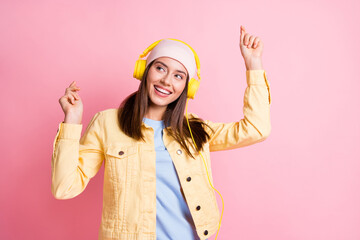 Photo of cute charming girl listen music dancing wear cap headphones yellow jacket isolated on pastel pink color background