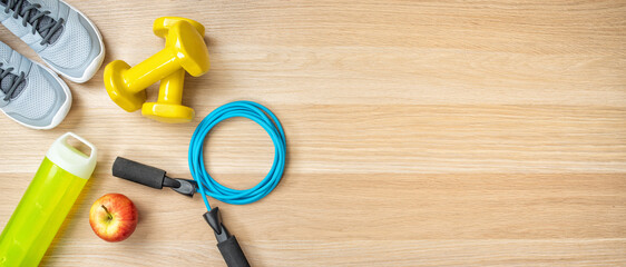 Fitness equipment on a wooden background with copyspace