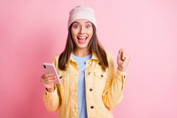 Wall Mural - photo of beautiful stylish young woman lucky win hold phone wear pink hat surprise isolated on vivid