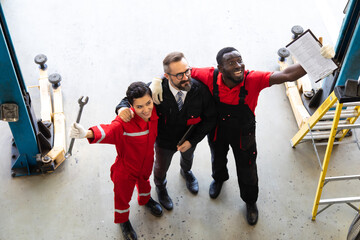 Wall Mural - Professional car mechanic Teamwork in workshop concept.  Diversity group of mechanics people in car service station. Celebration and success.