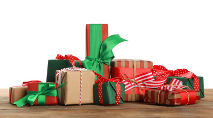 Many different Christmas gifts on wooden table against white background