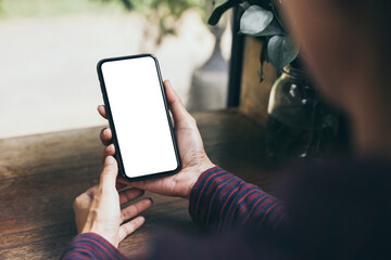 cell phone blank white screen mockup.woman hand holding texting using mobile on desk at office.background empty space for advertise.work people contact marketing business,technology