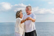 © lukyeee_nuttawut - Happy asian senior retired couple, relax smiling elder man and woman enjoying with retired vacation at sea beach outdoor. Health care, Family outdoor lifestyle