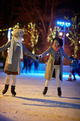 Wall Mural - Female friends skating together at ice rink. Skating, friendship, together