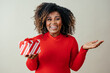 Portrait of a very excited woman holding red Christmas gift box gesturing with hand