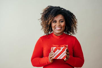 Portrait of a happy mid woman  holding red Christmas gift box