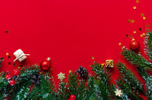 Fir Branches, Gifts And Cones On A Red Background With Space For Text.Christmas And New Year Background.