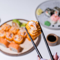 Wall Mural -  Closeup of hand  with chopsticks.