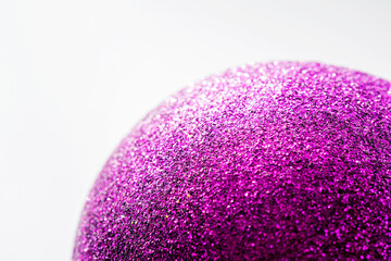 Wall Mural - Defocused purple glitter texture surface christmas ball abstract background. Selective soft focus, shallow depth of field.