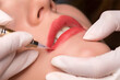 Permanent make up procedure. Lip makeup in tattoo salon.