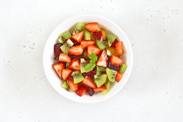 Wall Mural - Healthy food fruit salad from kiwi and strawberry.