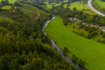 Small river in a green rural landscape; aerial view