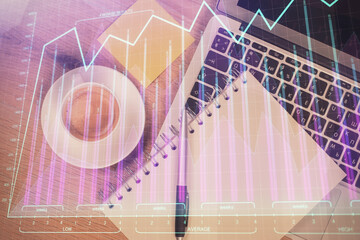 Double exposure of forex chart drawing over table background with computer. Concept of financial research and analysis. Top view.