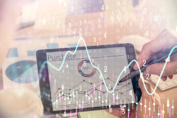 Double exposure of man's hands holding and using a phone and financial chart drawing. Market analysis concept.