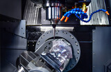 The 5-axis machining center cutting the engine cylinder block with solid ball end mill tool. Hi-precision automotive manufacturing process by multi-axis CNC milling machine.