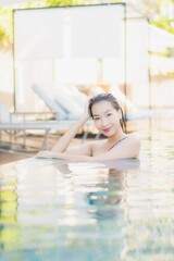 Portrait beautiful young asian woman relax smile leisure around outdoor swimming pool nearly sea