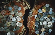 Directly Above Shot Of Coins On Rusty Metallic Plates