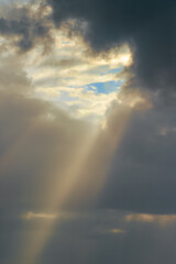 Wall Mural - Sunbeams shine through the storm clouds after tropical storm