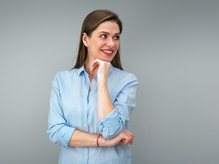 Happy woman with big smile wearing blue shirt looking away